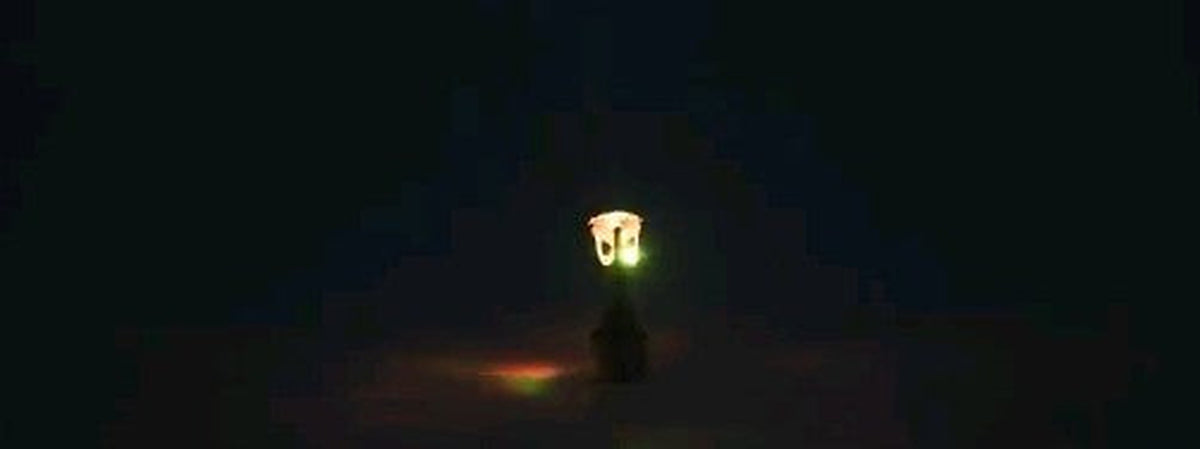 Yellow LED stud earring glowing in the dark
