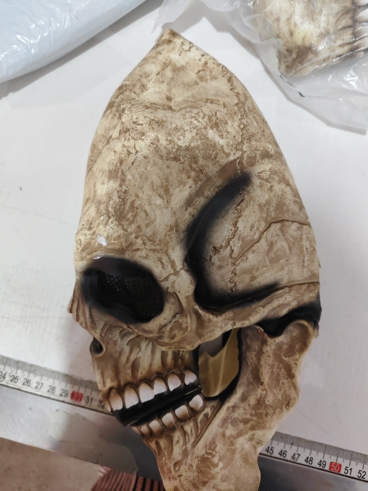Side profile of the skull mask showing jaw hinge