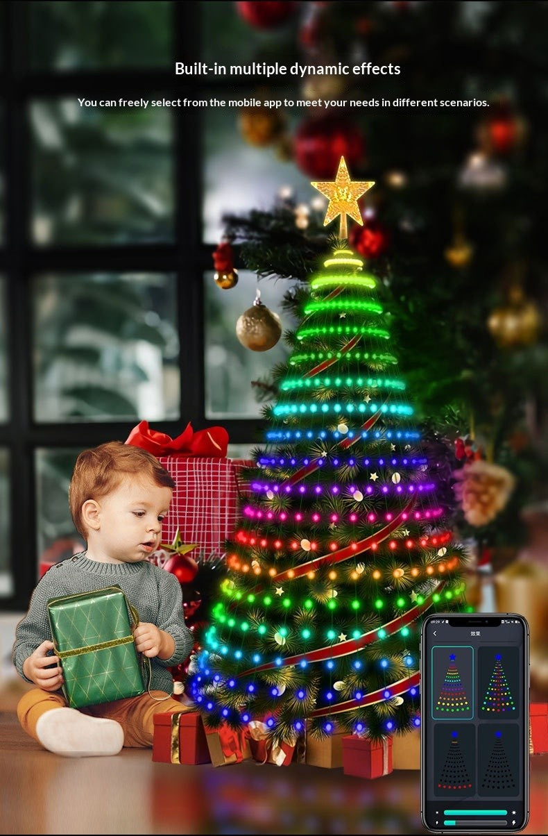 Toddler sitting by a tree lit with multicolor dynamic light effects chosen from the app