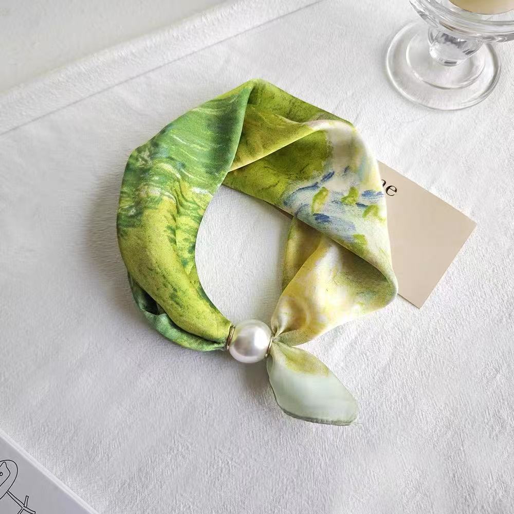 Green landscape neckerchief fastened with the magnetic pearl clasp