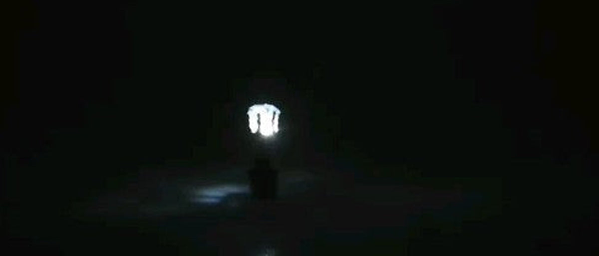 White LED stud earring glowing in the dark