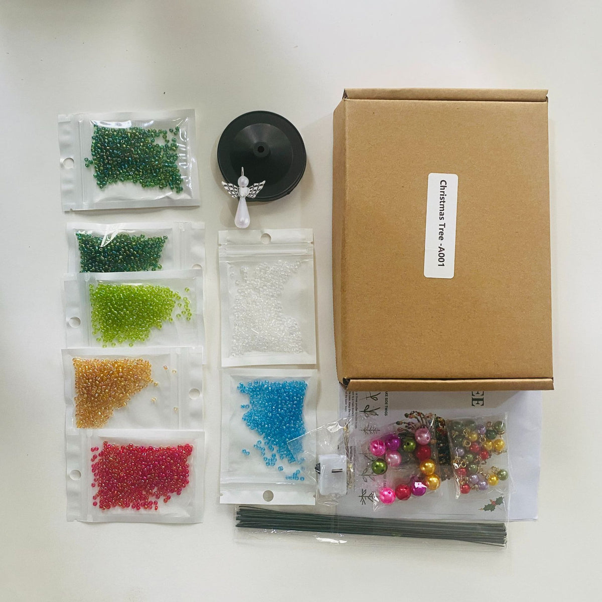 What's in the kit: bead packs, wire stems, base, angel topper, ornaments, lights and guide