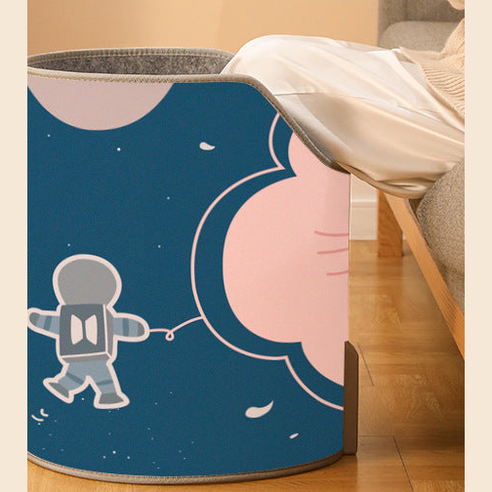 Cozy Foot Warmer Space Bear print beside an armchair