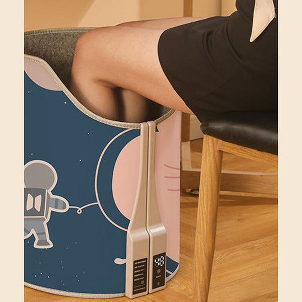 Cozy Foot Warmer in Space Bear print under a desk, wrapping both feet