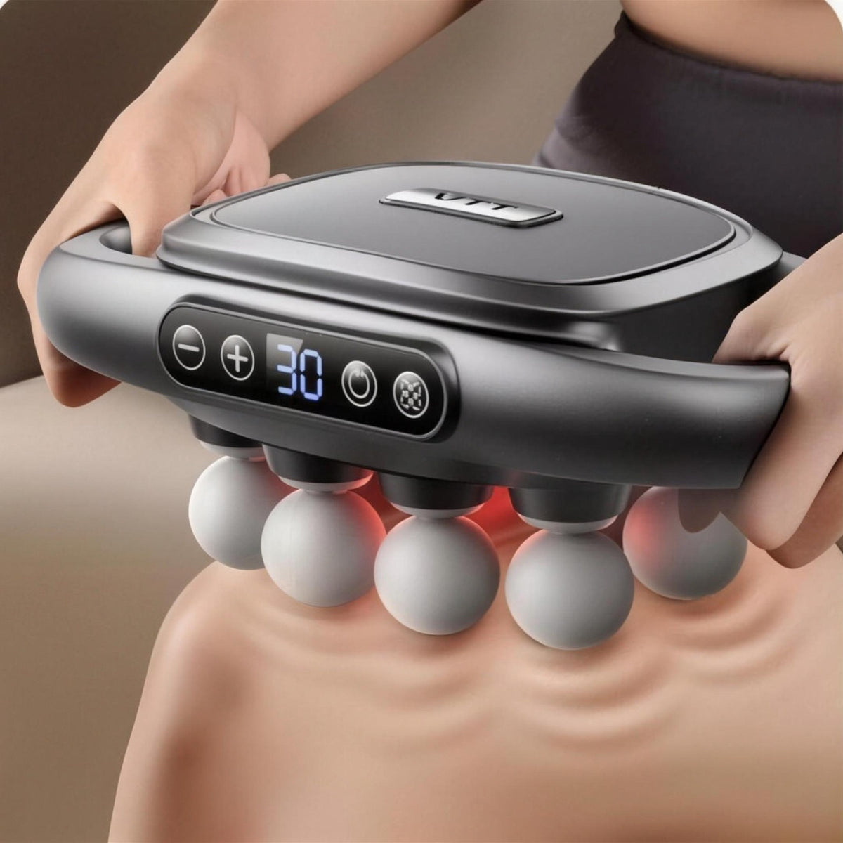 Top view of the massager held in both hands, with the display and buttons